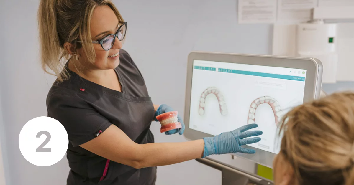 2a Dentist showing patient the scan results on a screen